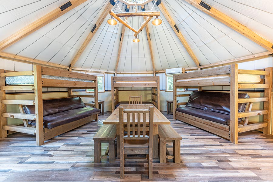 luxury interior yurt with mini-split and lots of beds at Cabin O' Pines Resort & Campground